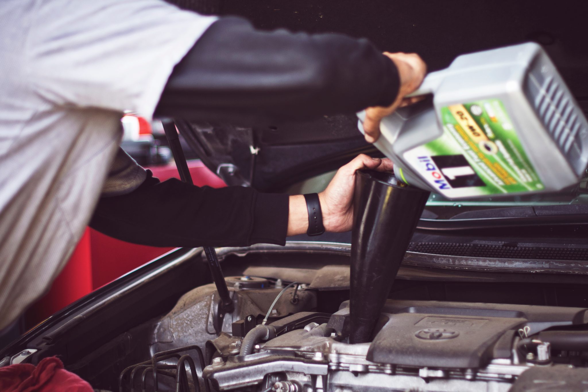 Mechanic preparing a vehicle for auto shipping 